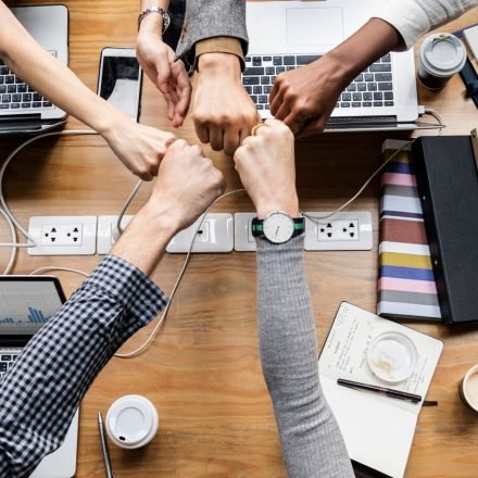 colleagues-giving-fist-bump_53876-64857